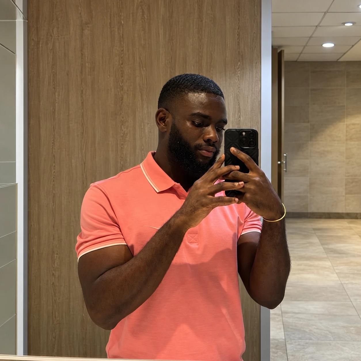 Emmanuel after, in a pink polo shirt