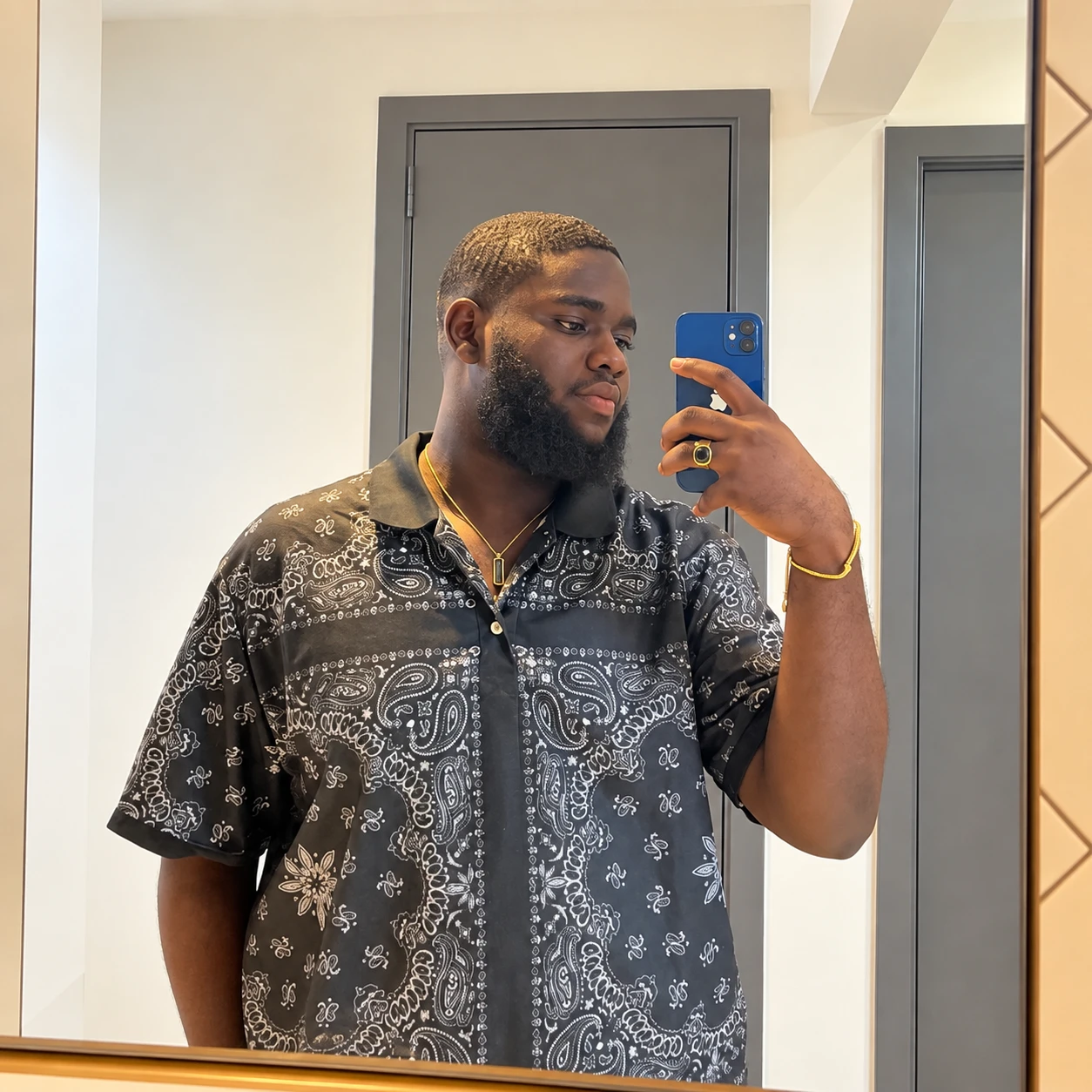 Emmanuel before, in a paisley shirt
